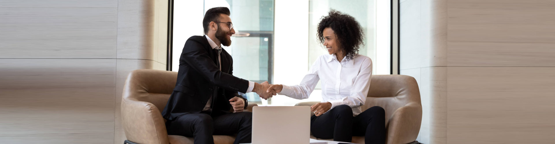 man in suite shaking hands